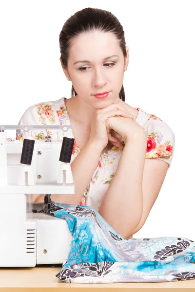 stock image Woman in summer blouse darning on the sewing machine