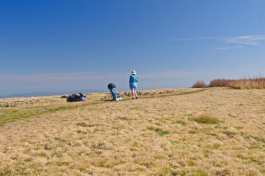 Taking a break on a mountain ridge clipart