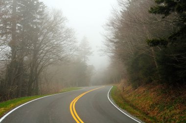 Mountain road in the mist clipart