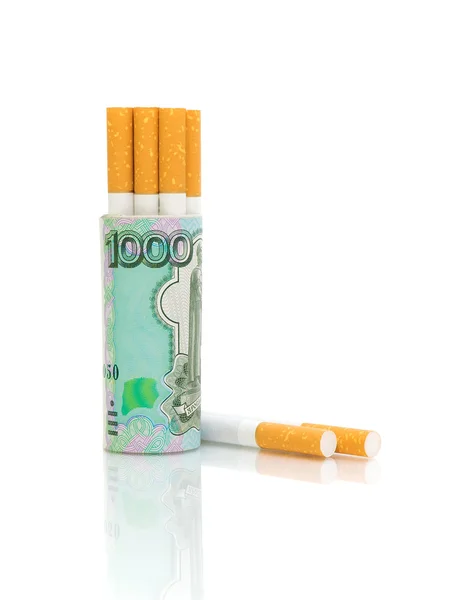 Cigarettes and banknotes on a white background — Stock Photo, Image