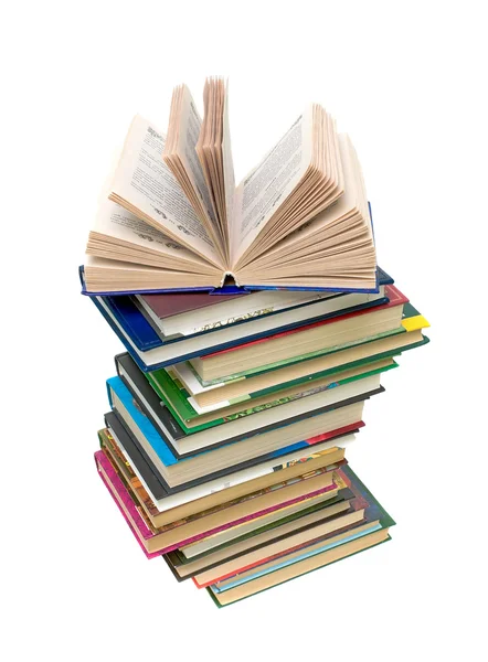 Open boek op een stapel boeken op witte achtergrond — Stockfoto