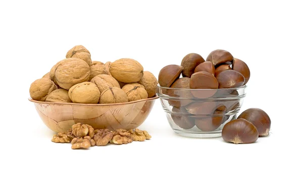 Walnuts and sweet chestnuts on a white background — Stock Photo, Image