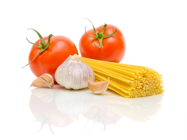 Tomatoes, garlic and pasta on a white background — Stock Photo, Image