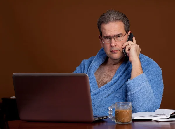 stock image Unhappily working in a bathrobe