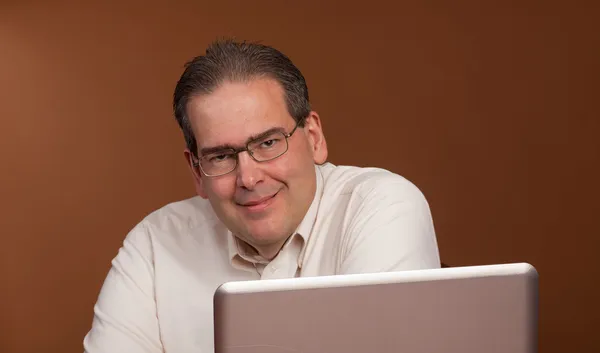Smiling Middle Age man at Computer — Stock Photo, Image