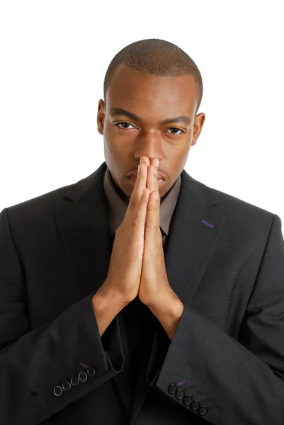 Homem de negócios orando usando gestos de oração olhos abertos — Fotografia de Stock