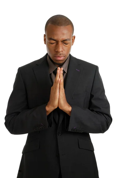 Деловой человек молится с закрытыми глазами — стоковое фото