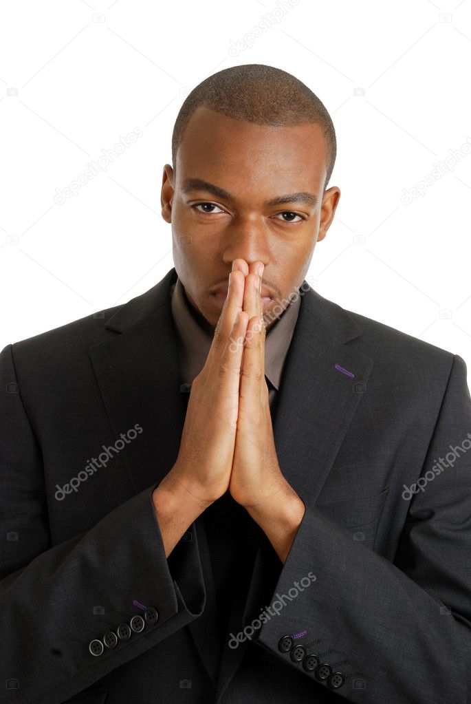 Business man praying using prayer gesture eyes opened