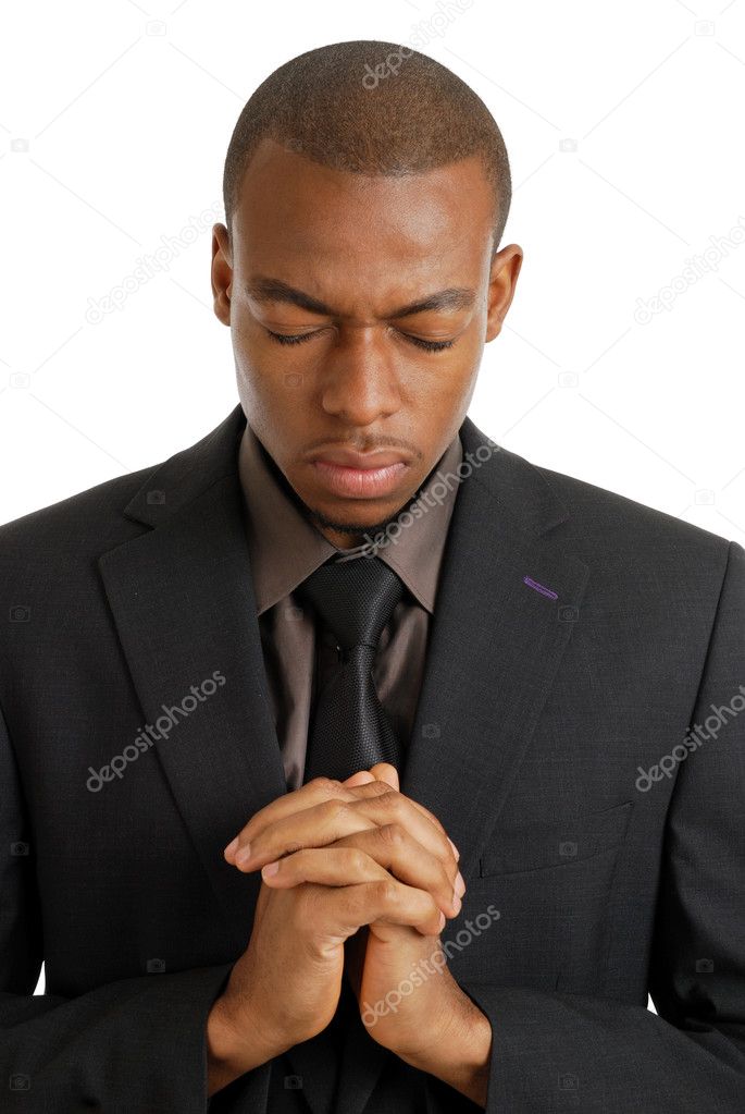 Business man praying with eyes closed