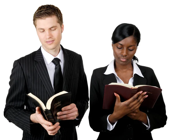 Multi-ethnic business couple reading bibles — Stock Photo, Image