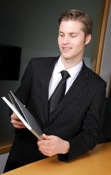 Caucasian business man holding a book — Stock Photo, Image
