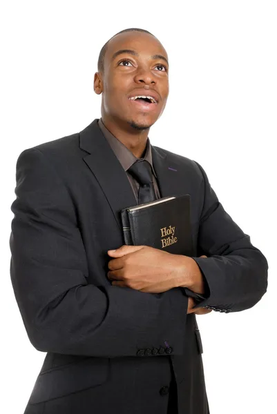 Mann hält Bibel in der Hand und zeigt Engagement lizenzfreie Stockbilder