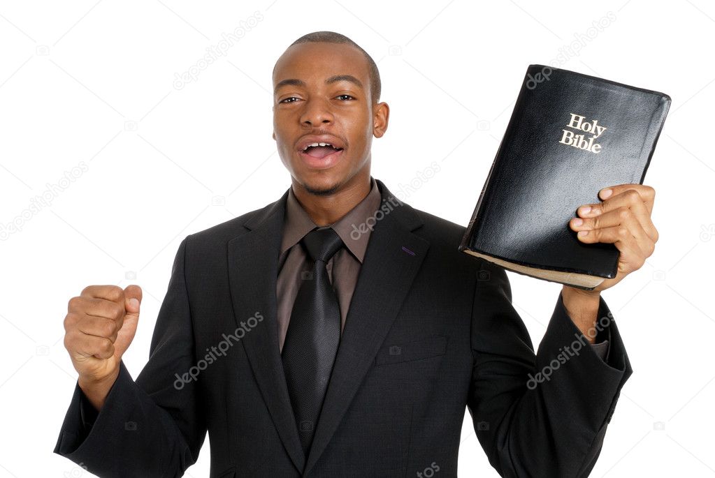 Man holding a bible preaching the gospel