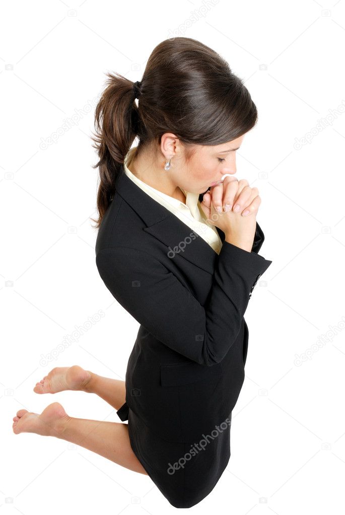 Business woman kneeling and praying