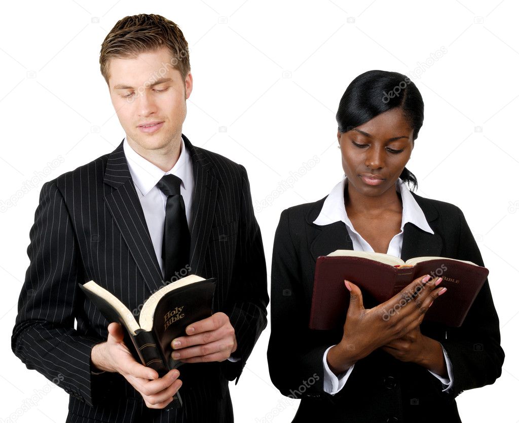 Multi-ethnic business couple reading bibles