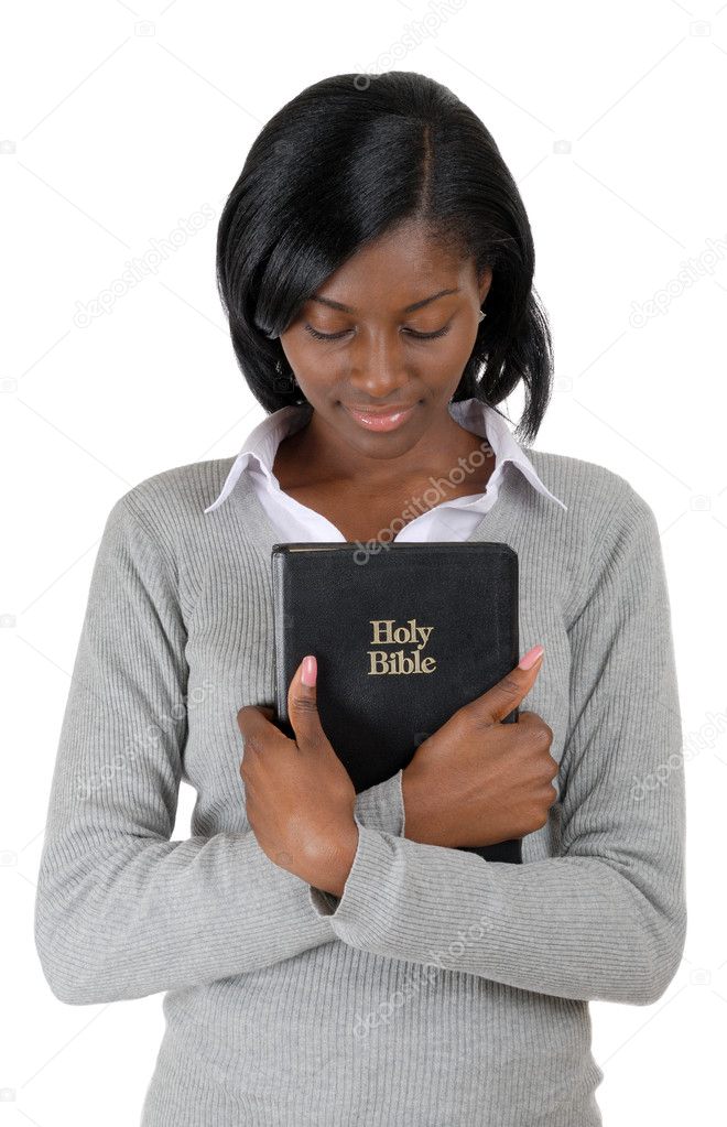 African american young woman holding a bible whilst looking down