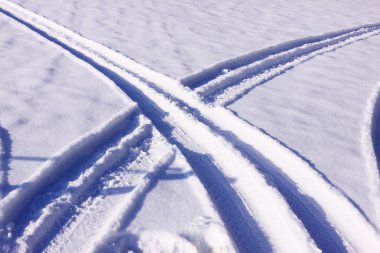 Tire tracks in the snow in winter clipart