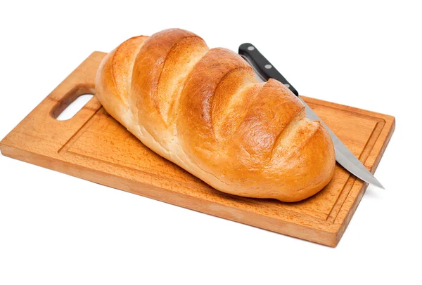 Pão fresco com faca na tábua de pão — Fotografia de Stock