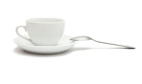 Белая чашка с ложкой и блюдце — стоковое фото