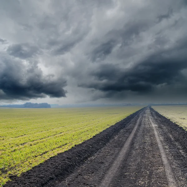 stock image Dirty road under dramatic sky. rain before