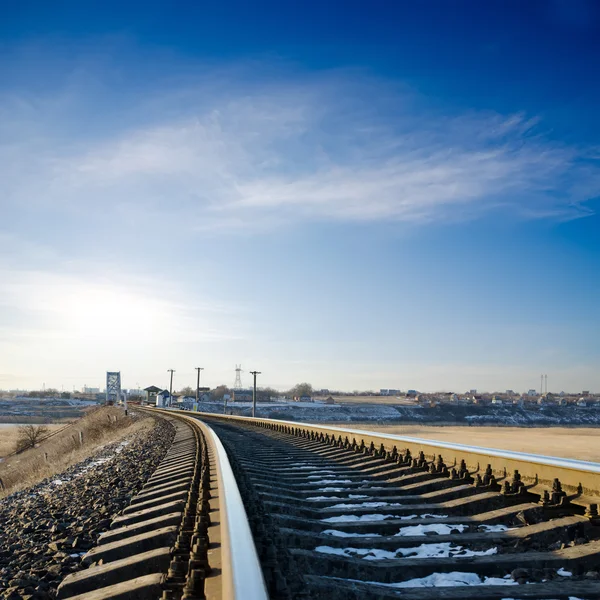 Railroad to horizon under deep blue sky in sunset — Stock Photo, Image
