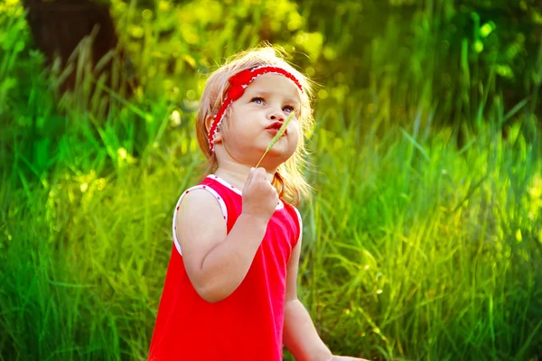 Outdoors Portrait of funny lovely little girl in red dress — Stock Photo, Image