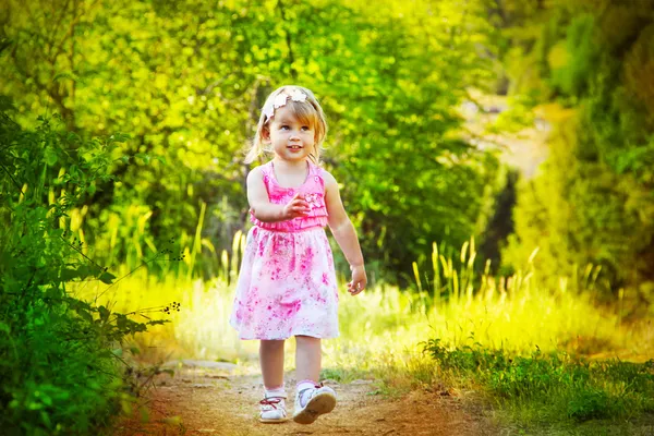 Happy funny little girl walking on road, nature outdoors — Stock Photo, Image