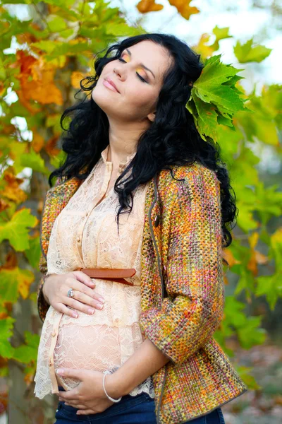 Kobieta w ciąży pieszcząc jej brzuch, na zewnątrz — Zdjęcie stockowe