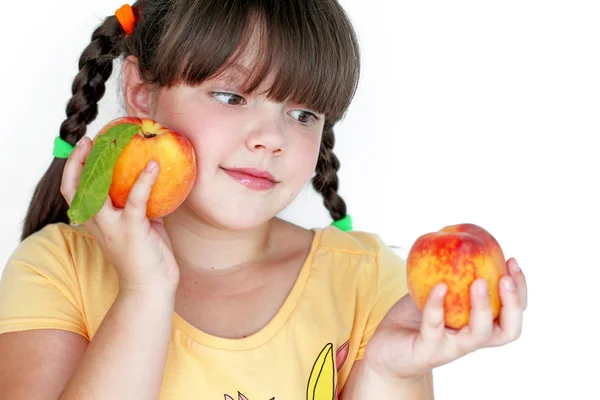 Lovely little girl with peaches isolated peach on white backgrou — Stock Photo, Image