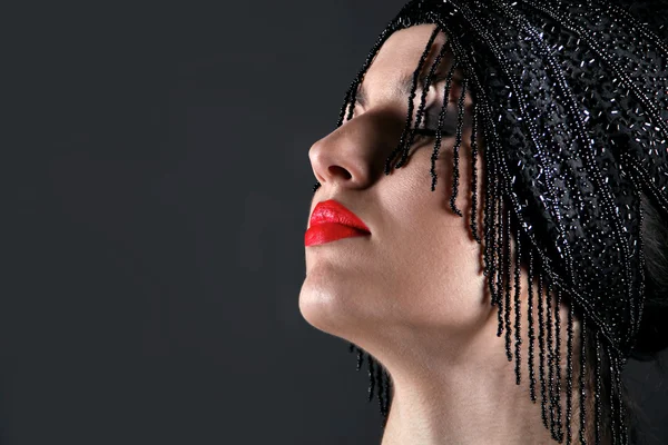 Fashion model face with red lip on black background — Stock Photo, Image