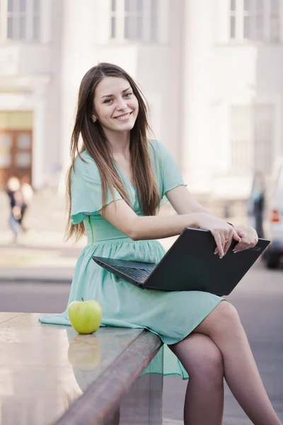 Flicka med bärbar dator utomhus — Stockfoto