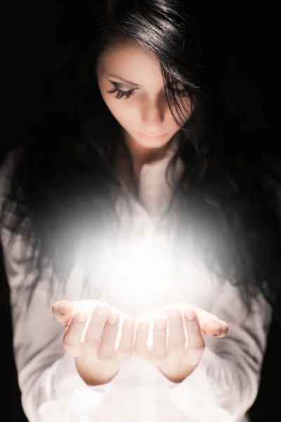 Brunette girl holding something special in her hands — Stock Photo, Image