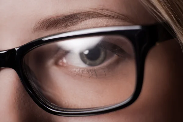 Eye shot through glasses — Stock Photo, Image