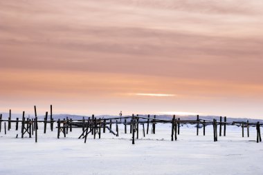 Red sky and wood pier on the Onsala fjord clipart