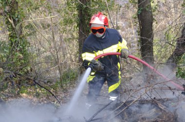 Firefighter fighting fire clipart