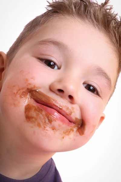 Мальчик ест шоколад — стоковое фото