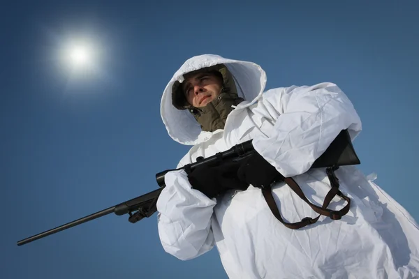 stock image Hunter in white camouflage suit with sniper