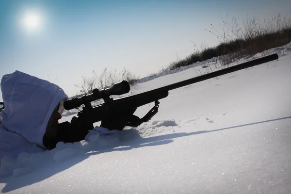 stock image Hunter in white camouflage suit with sniper