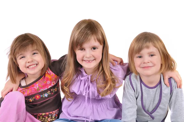 Drie prachtige lachende meisje op witte achtergrond — Stockfoto