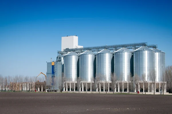 stock image Silver Grain Silos with blue sky in background