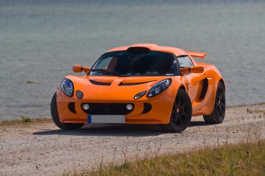 TALLINN, ESTONIA - JUNE 16, 2008: An orange Lotus Exige S front clipart