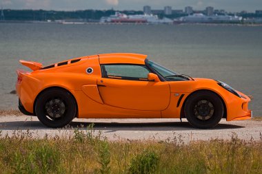 TALLINN, ESTONIA - JUNE 16, 2008: An orange Lotus Exige S side v clipart