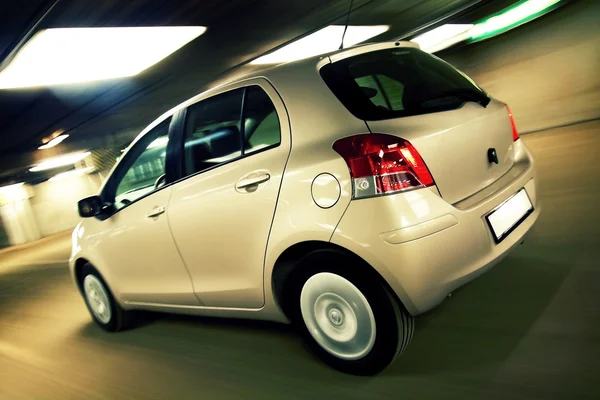 Car driving fast in parking house — Stock Photo, Image