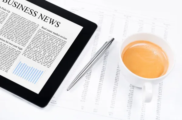 Modern working place with business news on digital tablet — Stock Photo, Image