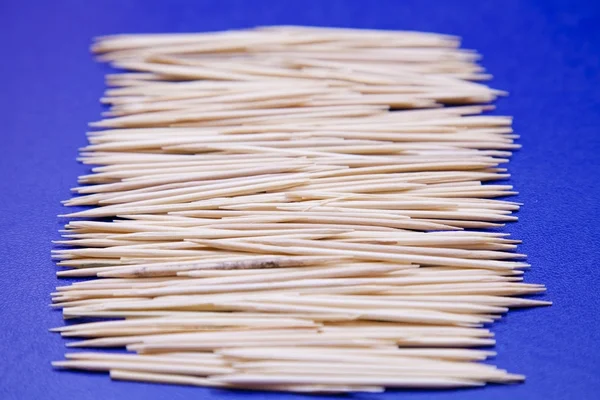 Toothpicks on blue background — Stock Photo, Image