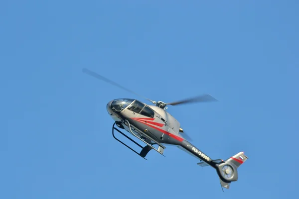 Flying helicopter on blue sky background — Stock Photo, Image