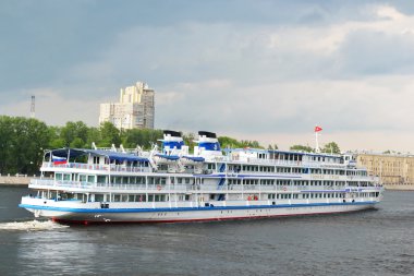 River cruise ship sailing on the river Neva clipart