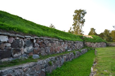 Wall of old Korela fortress at evening clipart