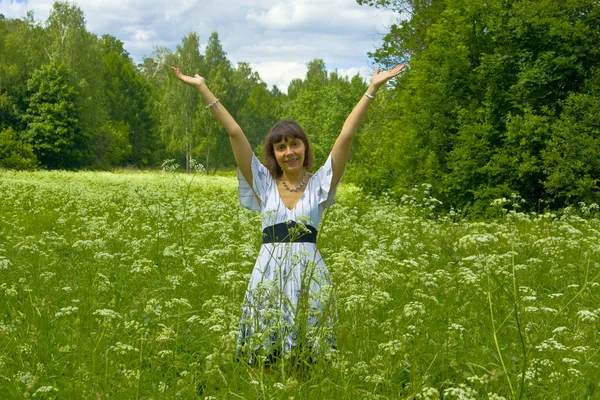 Young woman in white dress on a meadow in blossom — Stock Photo, Image