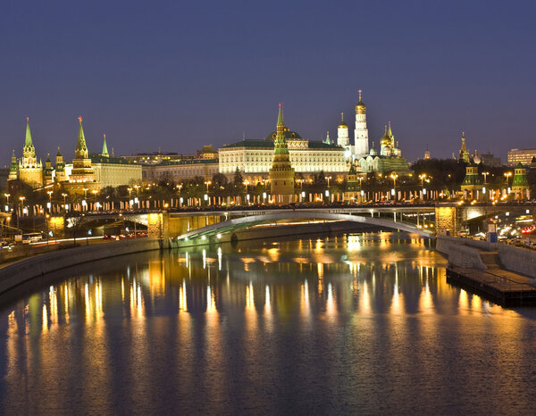 Moscow, Kremlin fortress with palace and cathedrals and Big Stone bridge on Moscow-river at night.